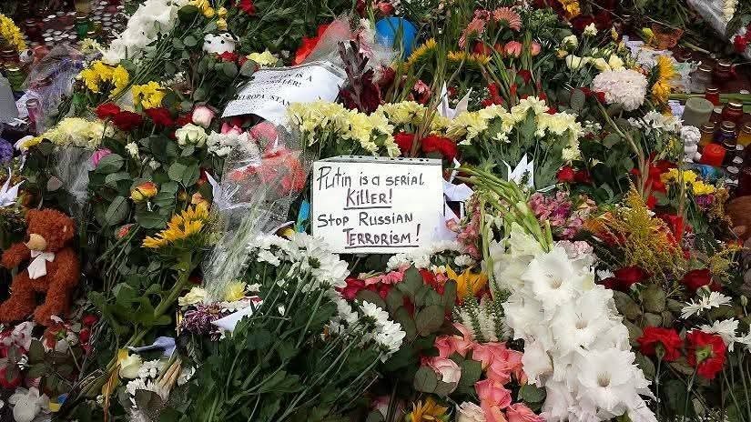 Memorial with a sign ‘Putin is a serial killer! Stop Russian terrorism!’