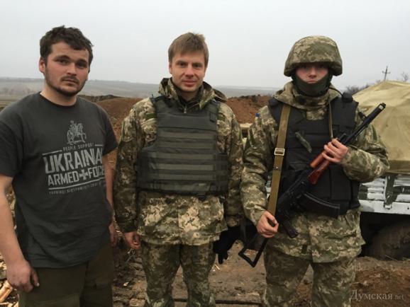 Honcharenko in body armour with soldiers at the front